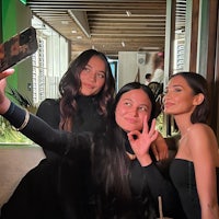 three women posing for a selfie at a restaurant