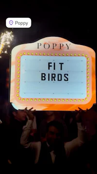 a man holding up a sign that says fit birds