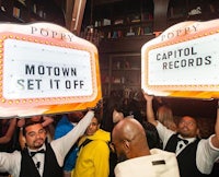 a group of people holding up signs that say motown capital set it records