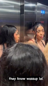 a group of women in an elevator talking to each other
