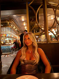 a woman sitting at a table in a restaurant