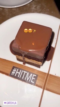 a piece of chocolate cake on a plate with emojis on it