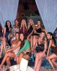 a group of women posing for a photo at a nightclub